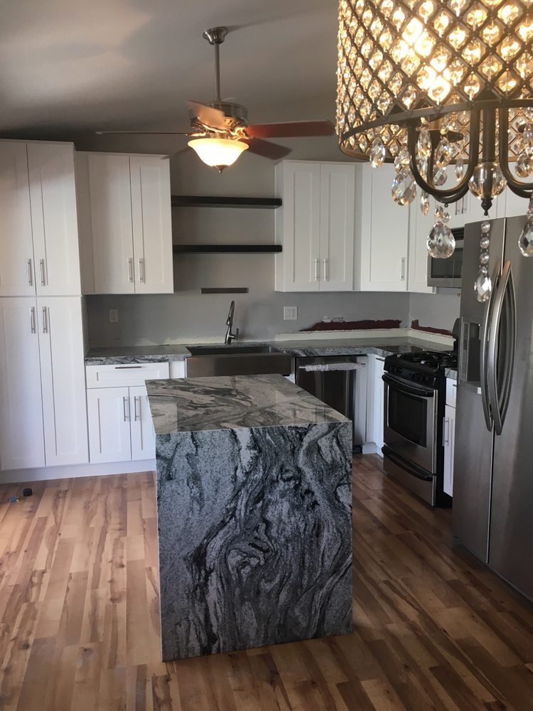 Granite waterfall island with dramatic veining