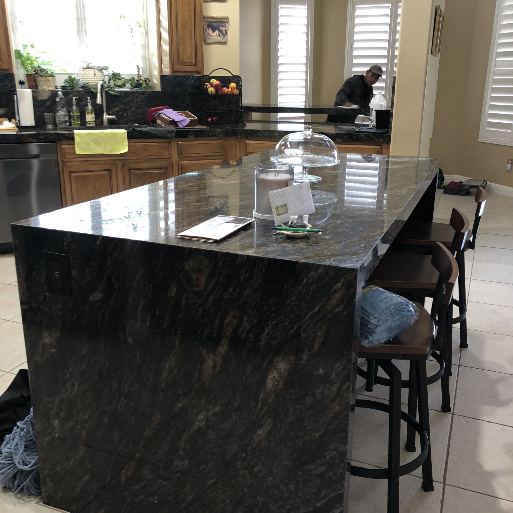 Rotech Granite crew installing a dark granite island